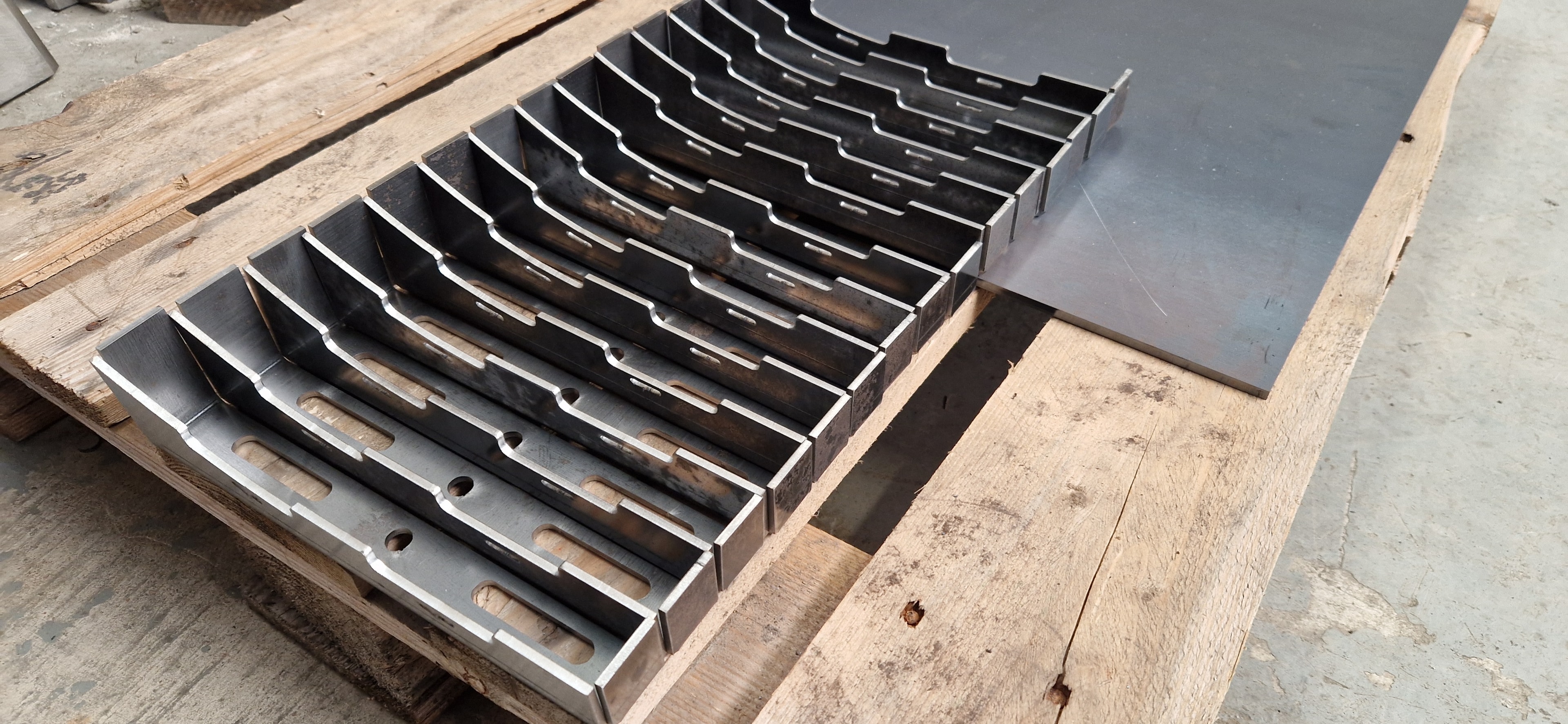 Laser cut and press brake formed steel trays on pallet